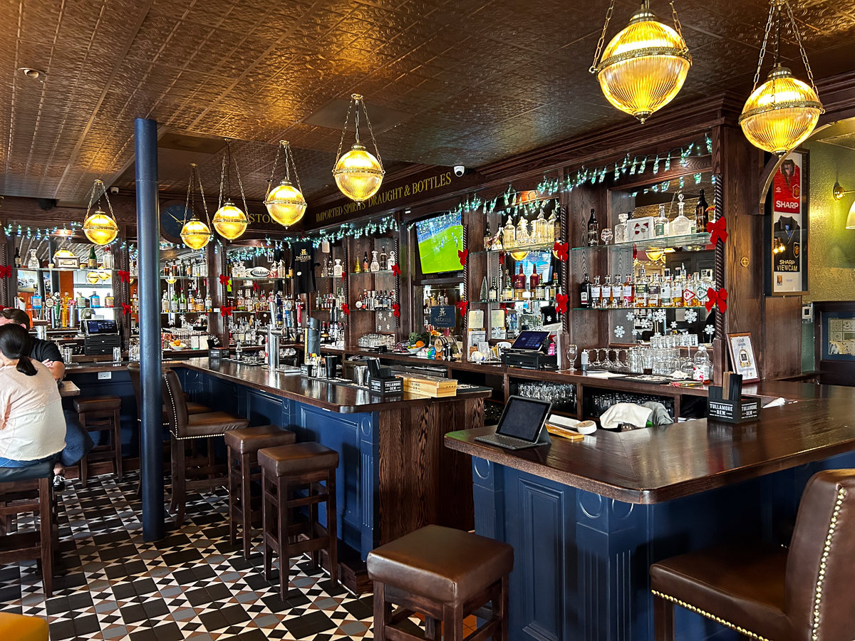 bar with stools and circle hanging light fixtures